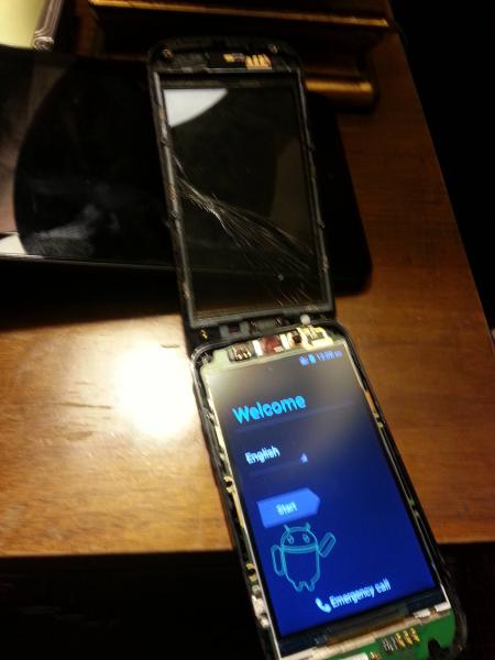 Picture of a Metro PCS ZTE with glass screen removed from the device body but still connected by a ribbon cable